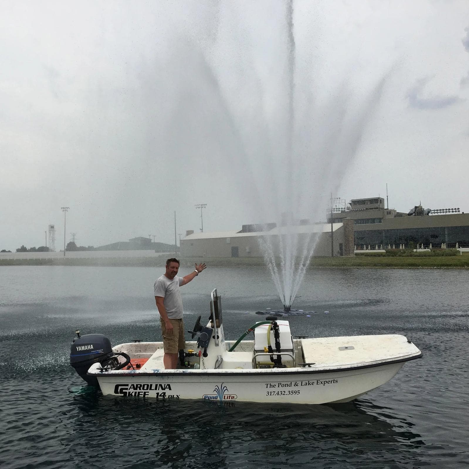 Blaine Hession on a workboat beside a running fountain